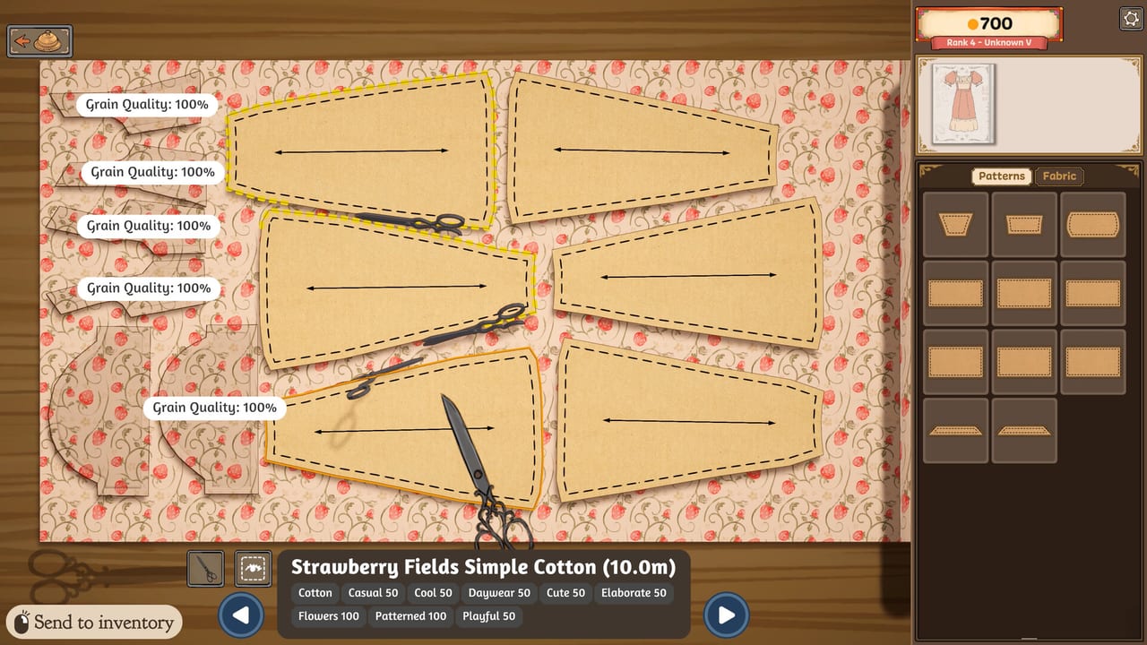 Dressmaker cutting table with grain-aligned pattern pieces on strawberry cotton